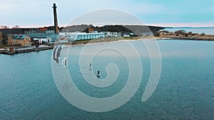 Aerial Drone View of a Corekites Kitesurfers Hydrofoiling  in Engure Port at in Baltic Sea