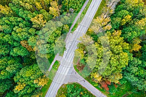 Aerial drone view of crossroad among autumn colorful trees