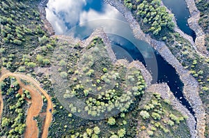 Aerial drone view of a dam full of water in the forest. Lefkara water reservoir Larnaca Cyprus