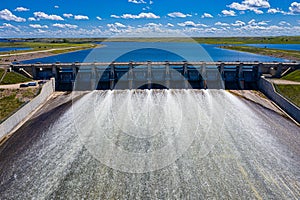 Aerial drone view of a dam over Lake Diefenbaker on a sunny day