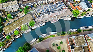 Aerial drone view of Delft town cityscape from above, typical Dutch city skyline with canals and houses, Netherlands