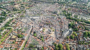 Aerial drone view of Delft town cityscape from above, typical Dutch city skyline with canals and houses, Netherlands