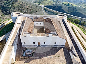Aerial drone view of a detail of San Marcos Castle in a mountain of Sanlucar de Guadiana village in Huelva province,