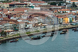 Aerial drone view of the Douro River and the Porto promenade with the old houses, rabelas, classic boats for the tourist routes of