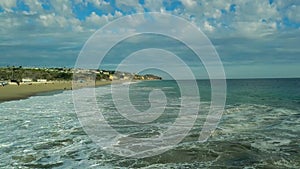 Aerial drone view drone is flying over beach upward amazing big waves. California USA