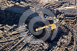 Aerial drone view of excavator loading the tipper truck