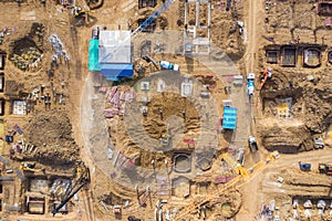 Aerial drone view of excavator loading the tipper truck at the construction site