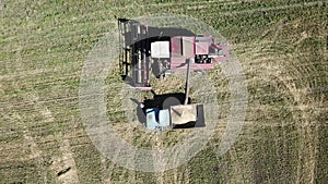 Aerial drone view of a filling process during farm work.