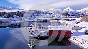 Aerial drone view of fishing boat in the port of northern Norway