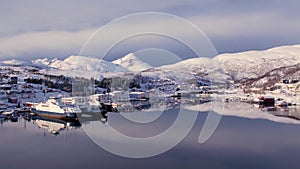 Aerial drone view of fishing boat in the port of northern Norway