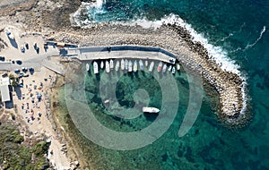 Aerial drone view of fishing boats moored at the harbor. moored at breakwater.