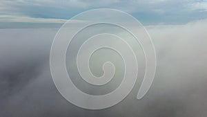 Aerial drone view flight over fog. Flight between white fluffy fog mist