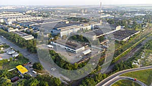 Aerial drone view flight over industrial zone on summer morning.