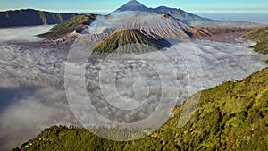 Aerial drone view fly forward and tilting up to reveal Bromo volcano, Indonesia