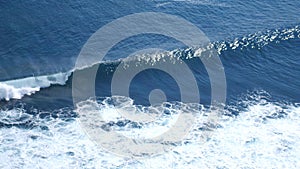 Aerial drone view of foaming waves in ocean