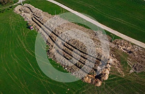 Aerial drone view of geothermal heating collector pit or trench in the ground. Excavation of ditch or holes for thermal heat