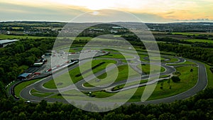 Aerial drone view of a go kart car race track circuit at sunset