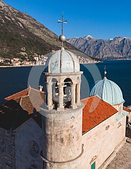 Aerial drone view of Gospa Od Skrpjela island, our Lady of the Rocks church, Montenegro, Boka Bay and Adriatic sea, with Perast