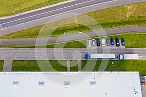 Aerial drone view of group of large modern industrial warehouse or factory buildings in suburban city area.Logistic transportation