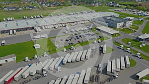 Aerial drone view of group of large modern industrial warehouse or factory buildings in suburban city area.Logistic transportation