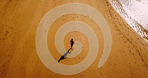 Aerial Drone View Of Healthy Sportive Woman Running On Beach