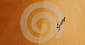 Aerial Drone View Of Healthy Sportive Woman Running On Beach