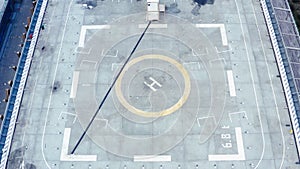 Aerial drone view of helipad on the roof of a skyscraper