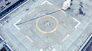 Aerial drone view of helipad on the roof of a skyscraper