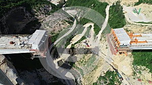 Aerial drone view on highway bridge road under construction. Construction of the viaduct on the modern new road.