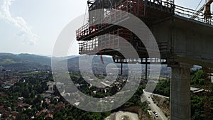 Aerial drone view on highway bridge road under construction. Construction of the viaduct on the modern new road.