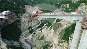 Aerial drone view on highway bridge road under construction. Construction of the viaduct on the modern new road.