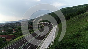 Aerial drone view on highway bridge road under construction. Construction of the viaduct on the modern new road.