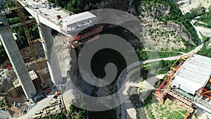 Aerial drone view on highway bridge road under construction. Construction of the viaduct on the modern new road.