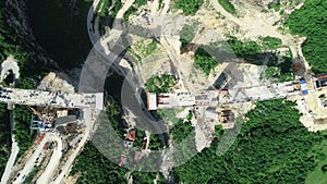 Aerial drone view on highway bridge road under construction. Construction of the viaduct on the modern new road.