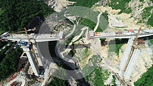 Aerial drone view on highway bridge road under construction. Construction of the viaduct on the modern new road.