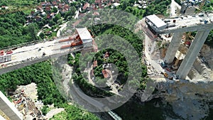 Aerial drone view on highway bridge road under construction. Construction of the viaduct on the modern new road.