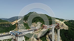 Aerial drone view on highway bridge road under construction. Construction of the viaduct on the modern new road.