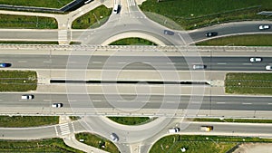 Aerial drone view of highway multi-level junction road with moving car at sunset. Active movement of transport cars vehicles in