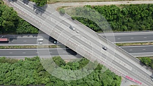 Aerial drone view of highway multi-level junction road with moving cars. Active movement of transport cars vehicles in