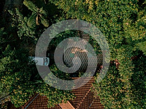 Aerial drone view of a house lawn surrounded with green trees in Jasin, Melaka, Malaysia