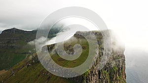 Aerial drone view of Kalsoy island hidden in the mist, Faroe Islands.