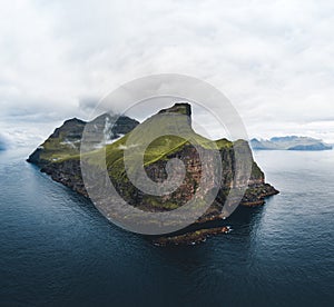 Aerial Drone view of Kalsoy islands on Faroe islands. Aerial panorama of a small white lighthouse located on the edge of