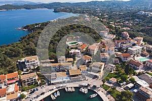 Aerial drone view of Kassiopi, village in northeast coast of Corfu island, Ionian Islands, Kerkyra, Greece in a summer sunny day,