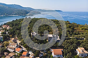 Aerial drone view of Kassiopi, village in northeast coast of Corfu island, Ionian Islands, Kerkyra, Greece in a summer sunny day,