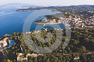 Aerial drone view of Kassiopi, village in northeast coast of Corfu island, Ionian Islands, Kerkyra, Greece in a summer sunny day,