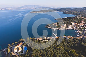 Aerial drone view of Kassiopi, village in northeast coast of Corfu island, Ionian Islands, Kerkyra, Greece in a summer sunny day,