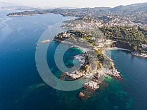 Aerial drone view of Kassiopi, village in northeast coast of Corfu island, Ionian Islands, Kerkyra, Greece in a summer sunny day,