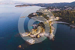 Aerial drone view of Kassiopi, village in northeast coast of Corfu island, Ionian Islands, Kerkyra, Greece in a summer sunny day,