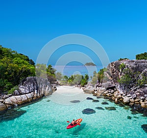 Aerial drone view of in kayak in crystal clear lagoon sea water during summer day near Koh Lipe island in Thailand. photo