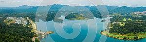 Aerial drone view of lake scenery with turquoise water in Tasik Puteri, Bukit Besi, Terengganu, Malaysia.